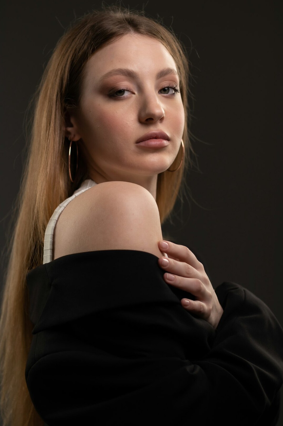 Studio portrait of a young woman with straight blonde hair