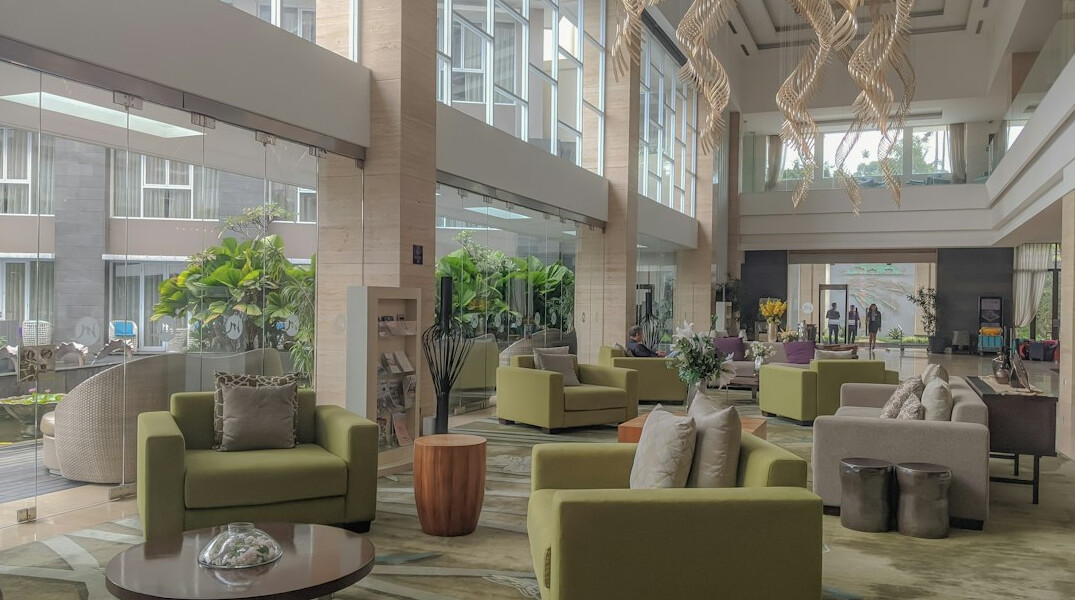 Bright modern office reception area with seating and plants